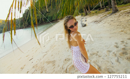 The tanned woman dances cool and appetizing on the beach of Koh Chang island in Thailand. Booty dancing twerk. Concept travel, walks, rest in sea, tropical resort traveling tourism summer holidays 127755211