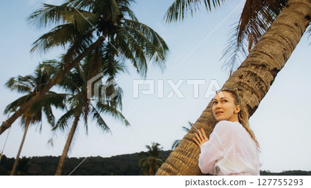 Woman in a white tunic shirt on beach, near stormy sea, tilted p Woman in a white tunic shirt on beach, near stormy sea, tilted p 127755293