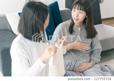 Mother and daughter talk about a bright future while preparing for birth Mother and daughter talk about a bright future while preparing for birth 127755726