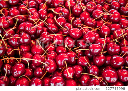Fresh red cherries closeup, summer fruits, outdoor market stall 127755996