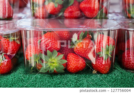 Fresh strawberry fruit in plastic trays for sale at farmers outdoor market 127756004