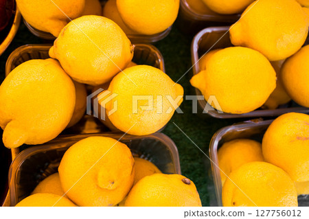 Lemons In fruit market display, outdoor farm market stall Lemons In fruit market display, outdoor farm market stall 127756012