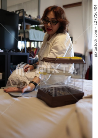 Veterinarian taking care of small rodent in clinic Veterinarian taking care of small rodent in clinic 127756404
