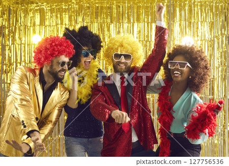 Happy multiethnic friends have fun dancing and laughing at a bright party. 127756536