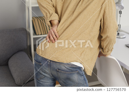 Man worker struggle with back muscular spasm Man worker struggle with back muscular spasm 127756570
