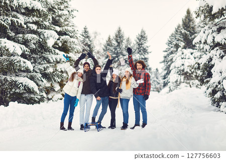 Excited friends waving hands in winter woods Excited friends waving hands in winter woods 127756603
