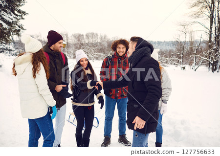 Happy friends meeting in winter park 127756633