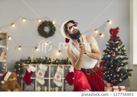Cheerful funny Santa man standing and singing in microphone 127756801