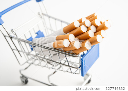 Cigarette on US dollar banknotes, cost, trading, marketing and production, No smoking, import export concept. Cigarette on US dollar banknotes, cost, trading, marketing and production, No smoking, import export concept. 127756832