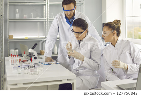 Male and female scientists working in laboratory, doing medical research Male and female scientists working in laboratory, doing medical research 127756842
