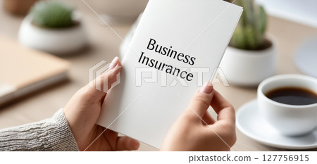 Business insurance liability concept hands document coffee cup desk Business insurance liability concept hands document coffee cup desk 127756915