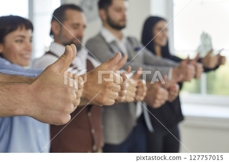 Group of happy business people showing sign of success. 127757015