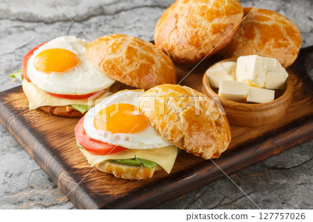 Hong Kong Style Fried Eggs Sandwich with tomato, cheese, lettuce close-up on wooden board. Horizontal 127757026