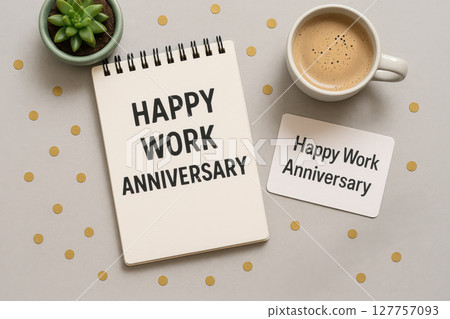 Happy work anniversary message written on notebook and card with coffee cup and green succulent plant on table creating happy work celebration atmosphere 127757093
