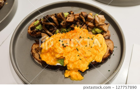 close up of two sourdough toast, one with scramble egg and avocado paste, another one with stir fried mushroom with copy space close up of two sourdough toast, one with scramble egg and avocado paste, another one with stir fried mushroom with copy space 127757890