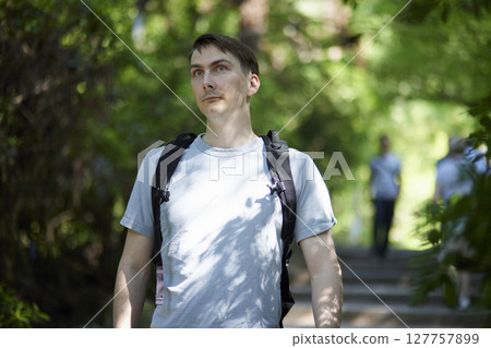 Tourists strolling along the approach to the shrine surrounded by greenery 127757899