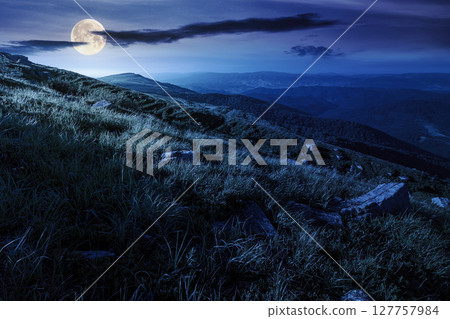 scenic view of alpine landscape in summer at night. picturesque outdoor background with grass on hill and blue sky with clouds. hiking through wonderful carpathian alps in full moon light scenic view of alpine landscape in summer at night. picturesque outdoor background with grass on hill and blue sky with clouds. hiking through wonderful carpathian alps in full moon light 127757984