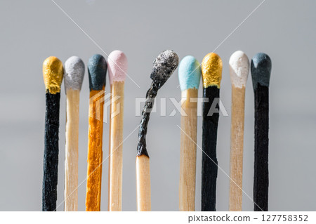 Group of colourful matches and one burned match. Diversity, inclusion abstract concept Group of colourful matches and one burned match. Diversity, inclusion abstract concept 127758352