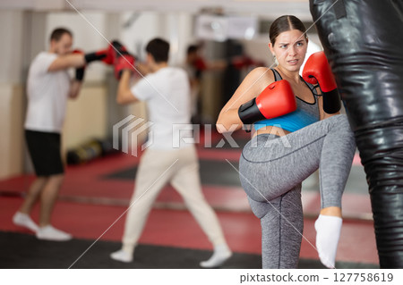 Woman kicking a pear tree 127758619