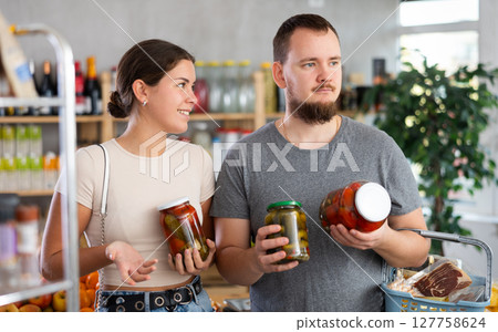 Spouses make choice choose consider canned vegetables in store 127758624