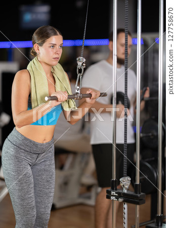 Woman doing arm workout Woman doing arm workout 127758670