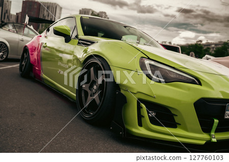 KYIV, UKRAINE - JUNE 8, 2024: Modified striking two-tone pink and lime green job Subaru BRZ KYIV, UKRAINE - JUNE 8, 2024: Modified striking two-tone pink and lime green job Subaru BRZ 127760103