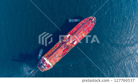Aerial view oil ship tanker vessel loading and unloading in oil terminal station refinery, Global business import export logistic transport sea freight cargo tanker, Red crude oil tanker ship at port. Aerial view oil ship tanker vessel loading and unloading in oil terminal station refinery, Global business import export logistic transport sea freight cargo tanker, Red crude oil tanker ship at port. 127760537