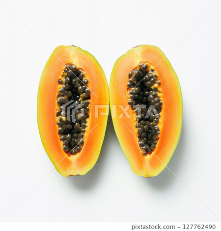 two half cut of ripe papaya with seeds isolated on white background 127762490