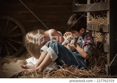 Children playing with a kittens Children playing with a kittens 127762559