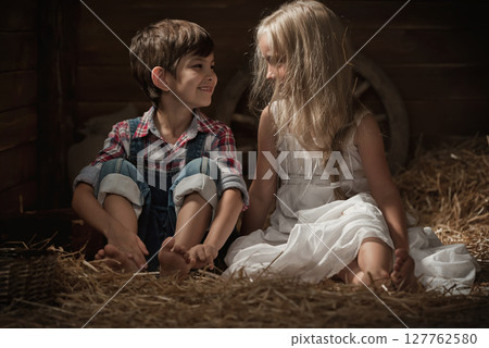Children rest lying on straw Children rest lying on straw 127762580