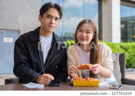 Young Asian couple eating fried chicken 127763204