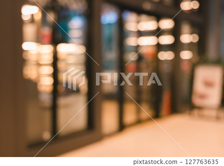 Defocused image of shop or cafe  with bokeh coloful night lights background 127763635