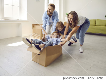 Happy family with children have fun on moving day Happy family with children have fun on moving day 127764284