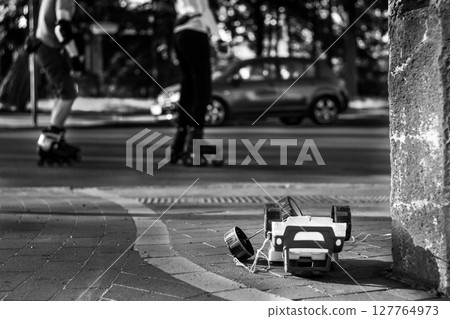 An abandoned toy sits at the corner of a city street An abandoned toy sits at the corner of a city street 127764973