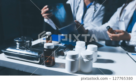 Male and female doctors are having a meeting in a hospital room. 127765380