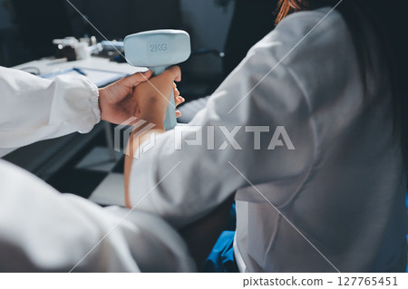 Unrecognizable uses blue hand weight during physical therapy session Unrecognizable uses blue hand weight during physical therapy session 127765451