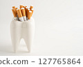 Cigarette in teeth model isolated on white background, damage the health of your teeth, No smoking. 127765864
