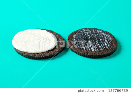 Chocolate cookie with cream on background. Chocolate cookie with cream on background. 127766789