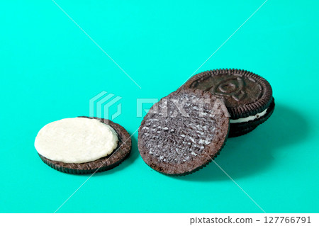Chocolate cookie with cream on background. Chocolate cookie with cream on background. 127766791