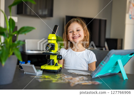Child amazed reaction after seeing something for the first time under a microscope. Concept of scientific discovery and the joy of learning Child amazed reaction after seeing something for the first time under a microscope. Concept of scientific discovery and the joy of learning 127766906
