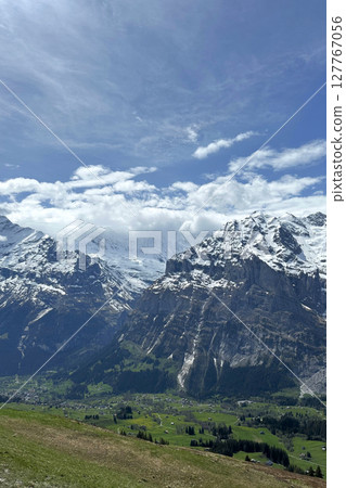 Swiss of towering mountains valleys under bright sky creates serene picturesque Switzerland landscape hiking destination. Swiss of towering mountains valleys under bright sky creates serene picturesque Switzerland landscape hiking destination. 127767056