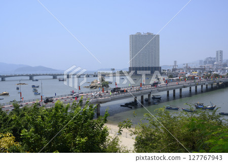 Bridge over the River Cai, skyscrapers and fishing boats in Nha Trang, Vietnam Bridge over the River Cai, skyscrapers and fishing boats in Nha Trang, Vietnam 127767943