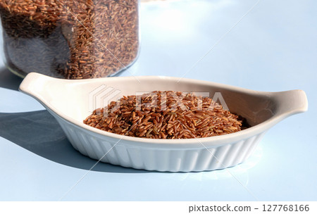 Healthy uncooked raw or brown red rice 127768166