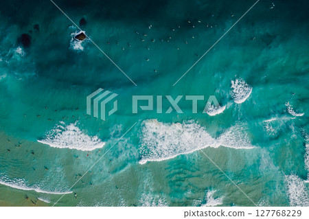 Top down view of blue ocean with crashing waves, drone shot 127768229