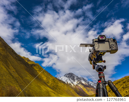 Camera capturing serene mountain landscape during daytime in Kyrgyzstan 127768961