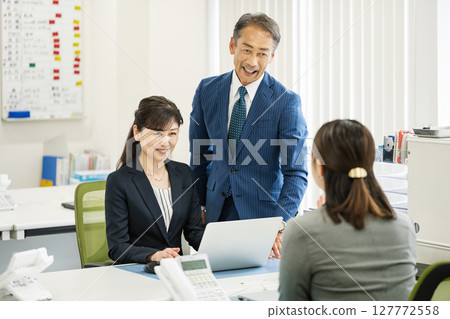 Middle-aged and senior business people working in an office 127772558