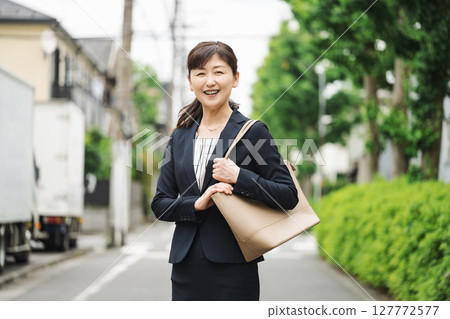 Outdoor portrait of a middle-aged woman in a suit Outdoor portrait of a middle-aged woman in a suit 127772577