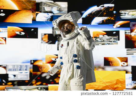 Space man on a deep space mission surrounded by stars and the vast galaxy, showcasing science and exploration. Astronaut with helmet travelling in the universe within, human curiosity. Space man on a deep space mission surrounded by stars and the vast galaxy, showcasing science and exploration. Astronaut with helmet travelling in the universe within, human curiosity. 127772581
