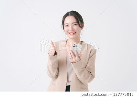 A woman with a suit with a smartphone A woman with a suit with a smartphone 127773015