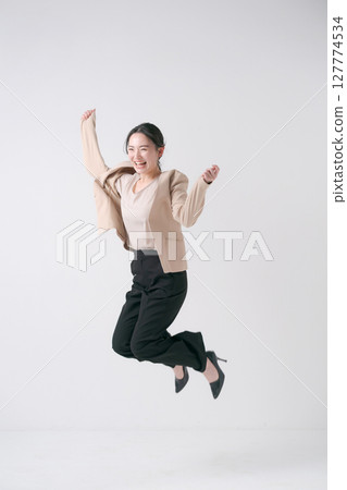 身穿西裝的女子跳躍 身穿西裝的女子跳躍 127774534